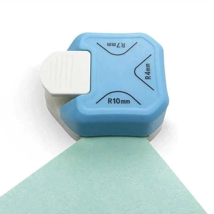 Mini paper corner cutter and rounder punch showing its compact design on a clean white craft table.