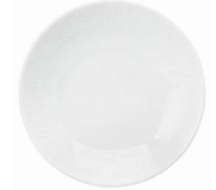 The Seychelles Dinnerware by Philippe Deshoulieres features a plain, round white ceramic plate with a slightly raised rim and smooth surface, evoking the timeless elegance of classic Limoges porcelain.